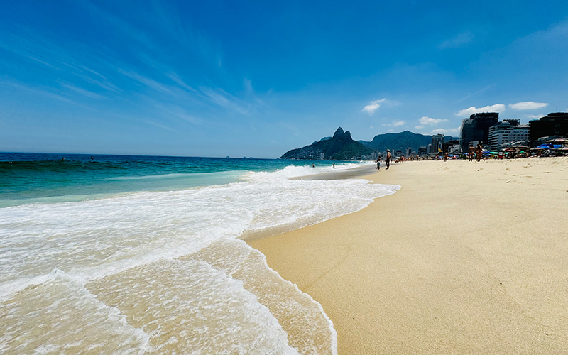 Golden sand and blue sea water at Ipanema Beach Rio De Janiero