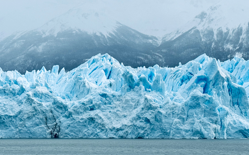 Perito Moreno Majestic Front Wall in front of mountains